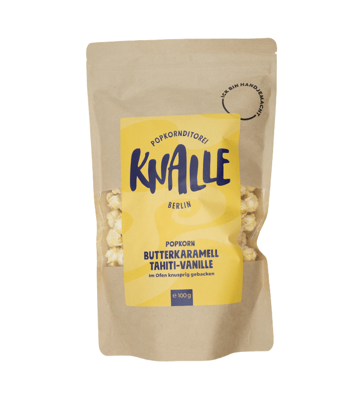 Braune Papiertüte mit Popcorn, gelbes Etikett mit "Knalle Popkorn Butterkaramell Tahiti-Vanille", 100g.